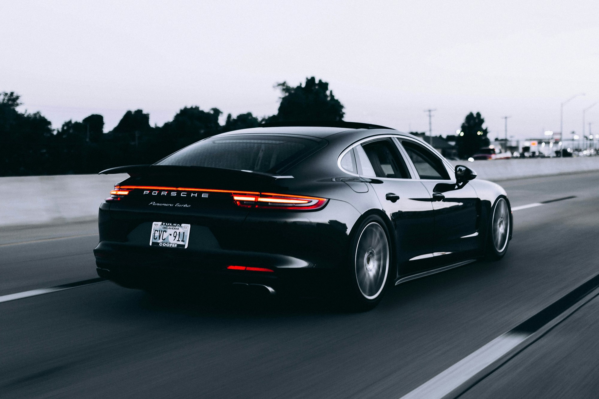 Silver prestige sports car on a winding road — illustrative automotive photography